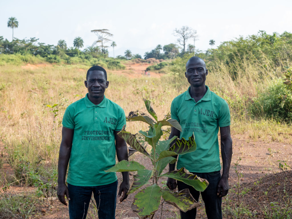Membres AJER, protection de l'environnement et reboisement devant un plan de teck, Lola, Guinée